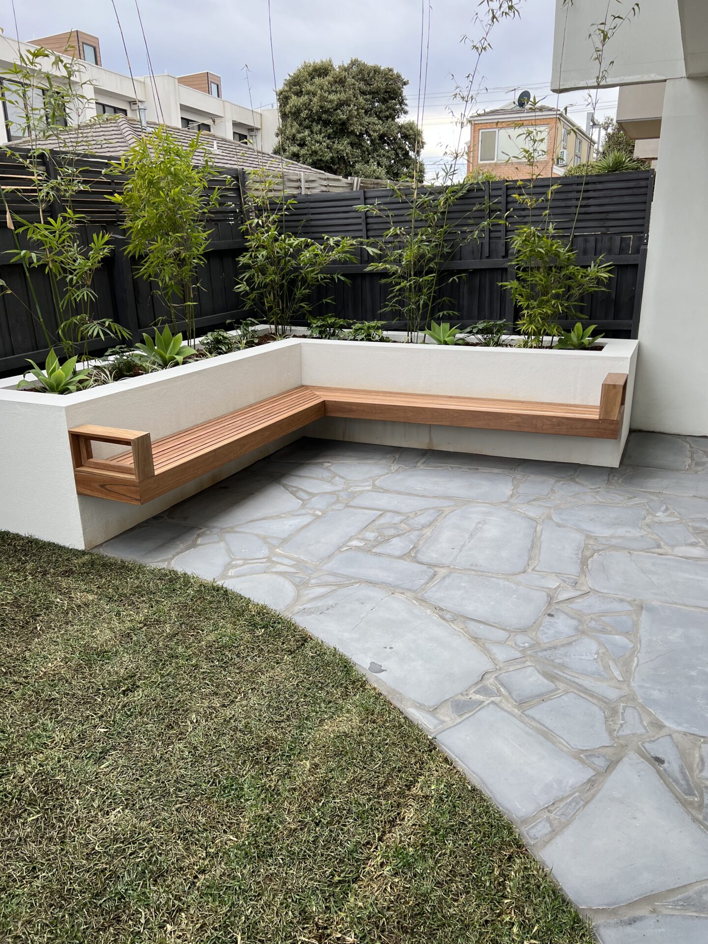 New planting, wall planters, and round pavers